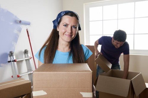 Movers handling boxed household items and furniture