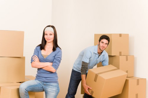 Professional movers handling stairs in a central London property