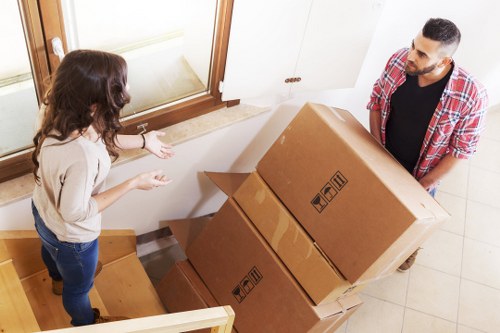 Packed moving boxes ready for transport with a removals van in Pimlico